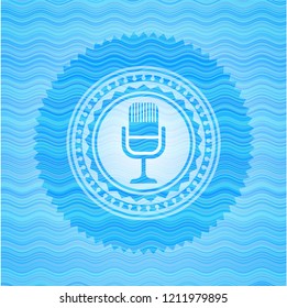 microphone icon inside water wavec oncept emblem.