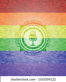 microphone icon on mosaic background with the colors of the LGBT flag