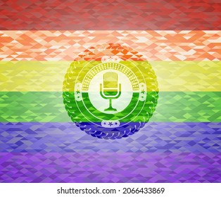 microphone icon on mosaic background with the colors of the LGBT flag. 