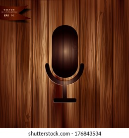 Microphone icon on wooden background
