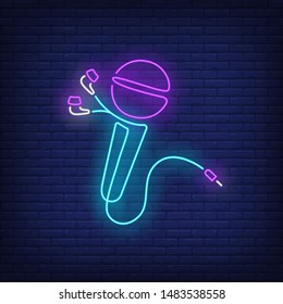 Microphone made of earphones cable neon sign. Music, sound, device design. Night bright neon sign, colorful billboard, light banner. Vector illustration in neon style.