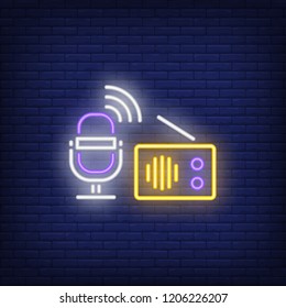 Microphone and radio receiver neon sign. Glowing neon microphone and radio receiver on dark blue brick background. Vector illustration for news, radio, broadcasting