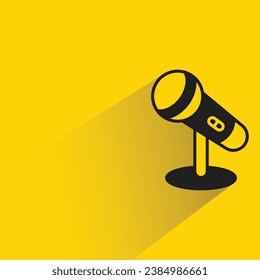 microphone with shadow on yellow background