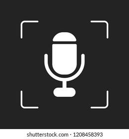 microphone. simple silhouette. White object in camera autofocus on dark background