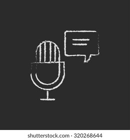 Microphone with speech bubble hand drawn in chalk on a blackboard vector white icon isolated on a black background.