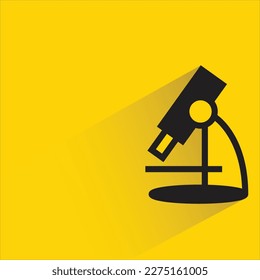 microscope with shadow on yellow background