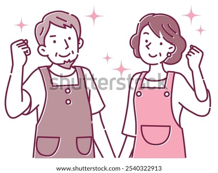 A middle-aged couple wearing aprons poses with a smile