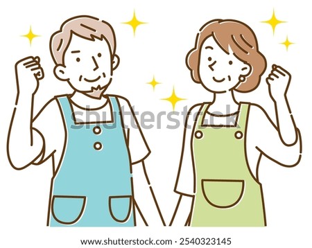 A middle-aged couple wearing aprons poses with a smile