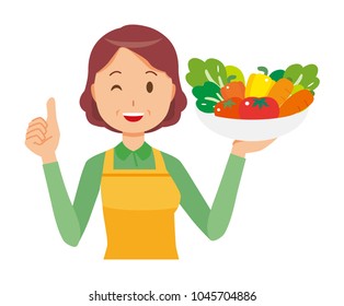 A middle-aged housewife wearing an apron has vegetables