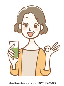 Middle-aged Woman Holding Green Juice And OK Pose