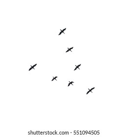 Migrating geese flying in formation - black vector silhouettes on white background
