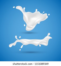 Milk splashes isolated on blue background. Liquid yogurt cream. Milk dairy drink.