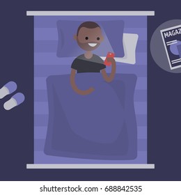 Millennial black character using a smartphone in bed / flat editable vector illustration, clip art