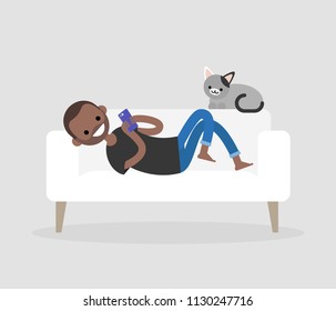 Millennial character lying on a sofa and checking the smartphone. Social networks and apps. Flat editable vector illustration, clip art. Modern lifestyle. Communication technologies.