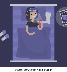 Millennial female character using a smartphone in bed / flat editable vector illustration, clip art
