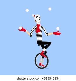 Mime performing a winter pantomime called a juggler on the unicycle with snowballs in the winter