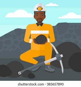 Miner holding coal in hands.
