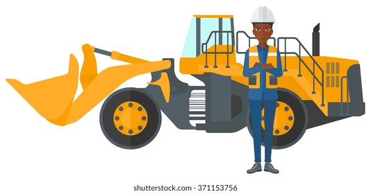 Miner with mining equipment on background.