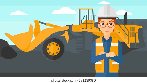 Miner with mining equipment on background.