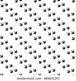 Minimal seamless pattern with dinosaur foots. Black and white colors. Vector illustration.