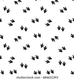 Minimal seamless pattern with dinosaur foots. Black and white colors. Vector illustration.