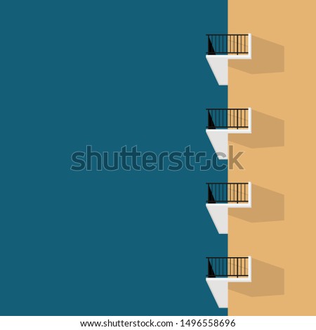 Minimal side view of the yellow vintage oldies apartment building with balcony on the blue sky