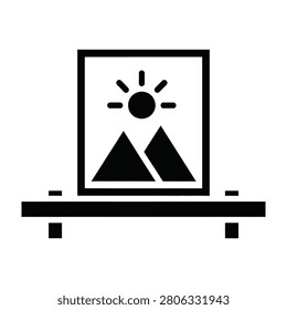 A minimalist black icon featuring a scenic mountain landscape picture frame resting on a floating shelf. Ideal for interior design, home decor, and art concepts.