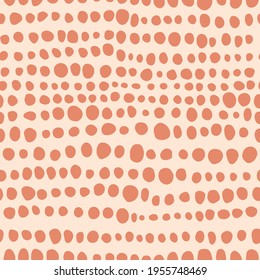 Minimalist boho seamless pattern with hand drawn dots in mid century style in an earthy palette. Modern abstract aesthetic background with trendy design for wallpaper, wrapping paper in beige.