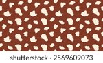 Minimalist seamless animal print, deer skin pattern with cream irregular textured spots on brown background for textiles, wallpapers, wrapping paper, fabric.