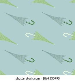 Minimalistic season seamless pattern with green and blue colored umbrella print. Pastel background. Decorative backdrop for fabric design, textile print, wrapping, cover. Vector illustration.