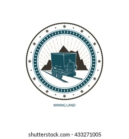 Mining Land,  Coal Mine Trolley against Mountains and Sunburst, Label and Badge Shaft or Emblem of the Mining Industry,  Vector Illustration