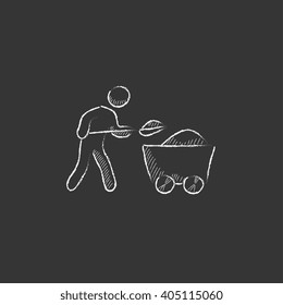 Mining worker with trolley. Drawn in chalk icon.