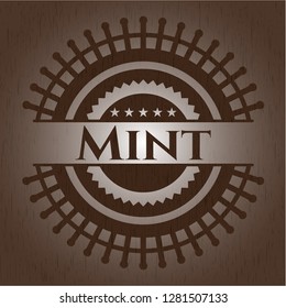 Mint badge with wooden background