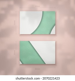 Mint color business card with abstract white ornament for your personality.