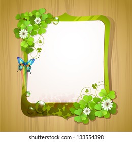 Mirror frame with clover and butterfly over wood background