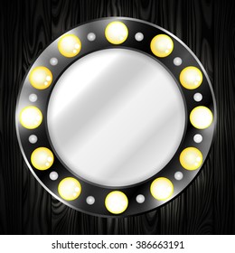 Mirror. Round. Black. Light bulbs. Shine. Wooden background.