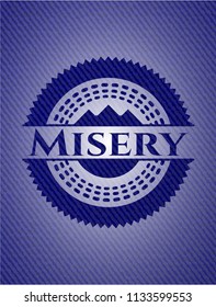 Misery badge with denim background