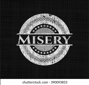 Misery written on a blackboard