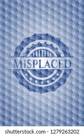 Misplaced blue badge with geometric pattern background.