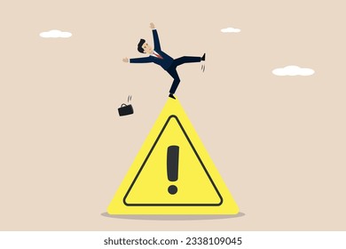 Mistake caution, business risk or trouble warning, or avoid danger concept, businessman slip caution falling on caution exclamation symbol.