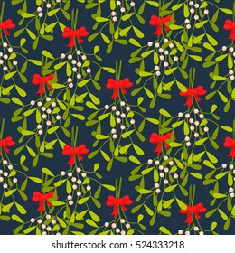 Mistletoe branches seamless vector pattern. Traditional plant tied with red bow. Green dense leaves on blue background.