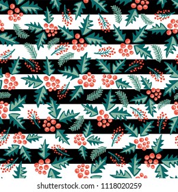 Mistletoes scattered seamless vector pattern on black and white stripes. Great for the Christmas season - greeting cards, gift wrap, fabric.
