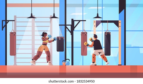 mix race boxers doing exercises with punching bag training healthy lifestyle boxing concept modern fight club interior horizontal full length vector illustration