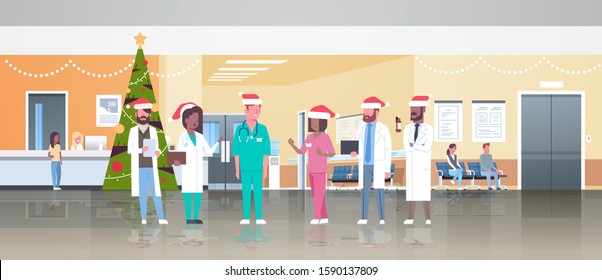 mix race doctors team in santa hats standing together medicine healthcare concept christmas new year holidays celebration modern hospital corridor interior full length flat horizontal vector