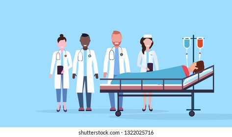mix race doctors team visiting patient man lying bed intensive therapy ward healthcare concept hospital room blue bckground modern medical clinic horizontal