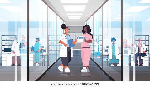 mix race doctors in uniform discussing during meeting in hospital corridor medicine healthcare concept