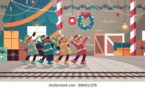 mix race elves in uniform having fun santa helpers team celebrating happy new year merry christmas holidays