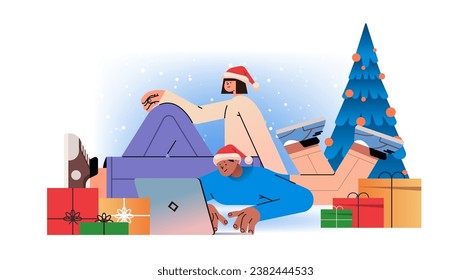 mix race man woman in santa hats near decorated christmas tree using laptop social media communication new year holidays celebration