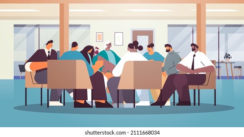 mix race people communicating while sitting in circle therapy group meeting addiction treatment concept