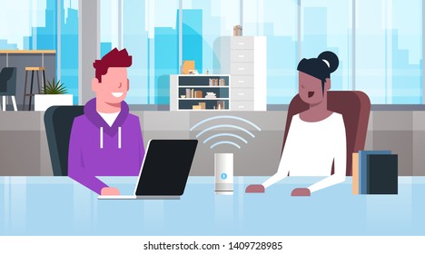 mix race people sitting at workplace desk man woman using intelligent smart speaker with voice recognition artificial intelligence assistance concept modern office interior flat horizontal portrait